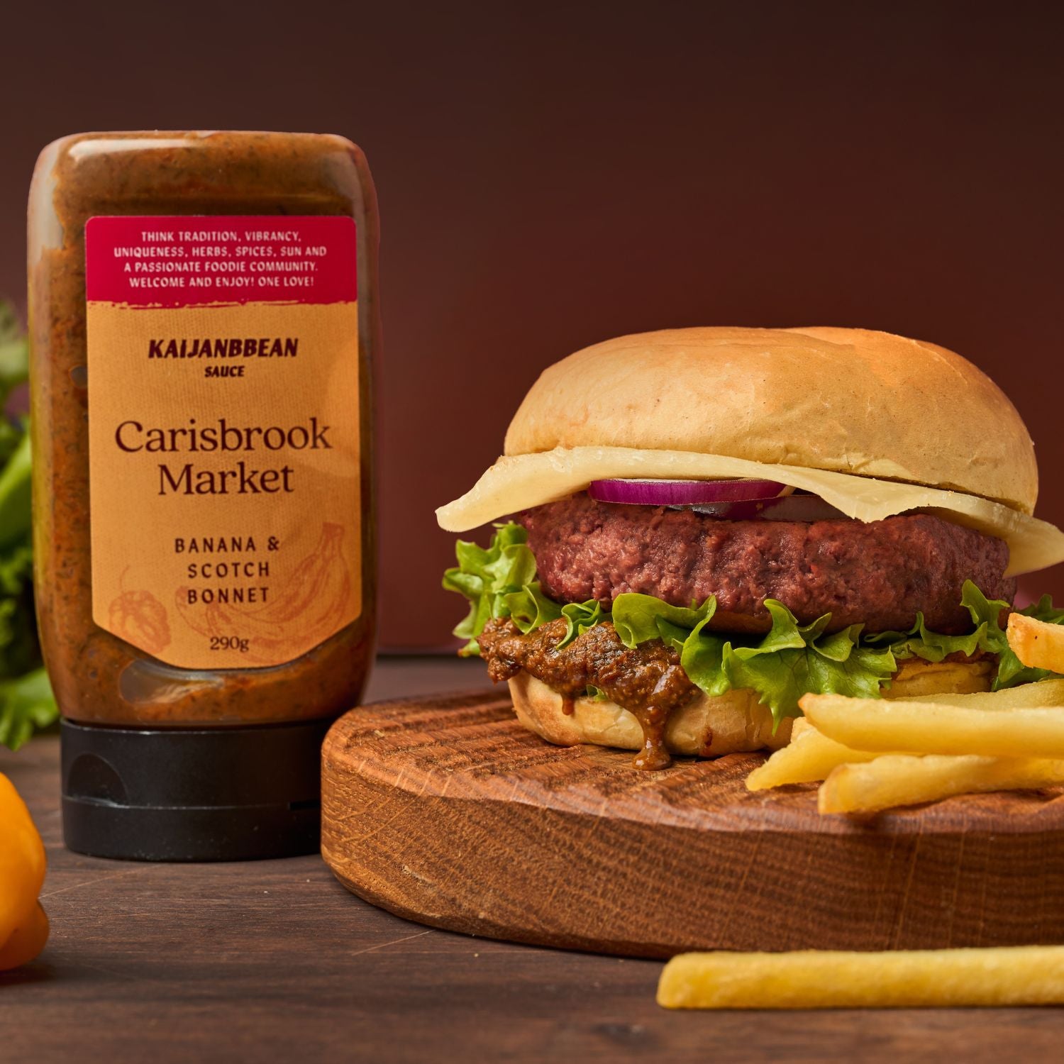 Burger with fries and Kajananbean sauce bottle on a wooden board